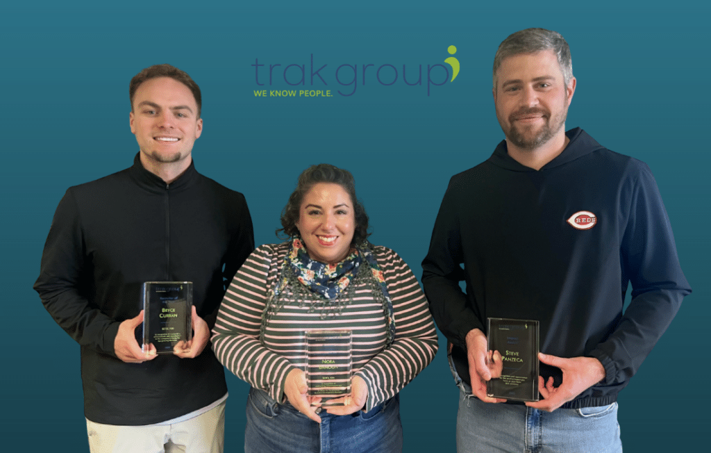 Bryce Curran, Nora Banoun, and Steve Panzeca holding awards at trak’s 2026 Town Hall.